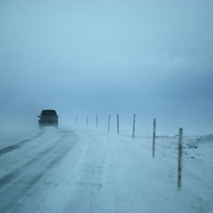 SUV driving on snow-covered road